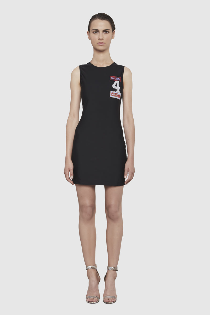 A woman is wearing a Shuko black sleeveless dress by Faith Connexion, a brand of luxury clothes