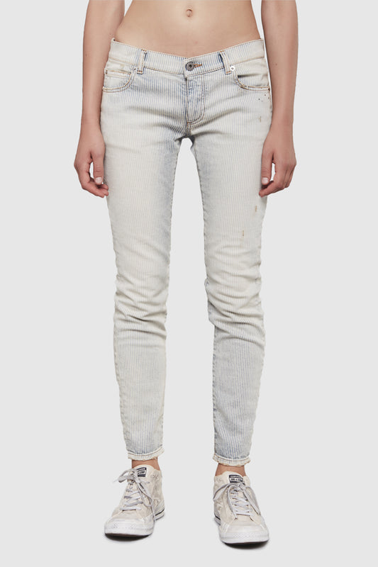 A woman is wearing a stripes denim slim pants by Faith Connexion, a brand of luxury clothes